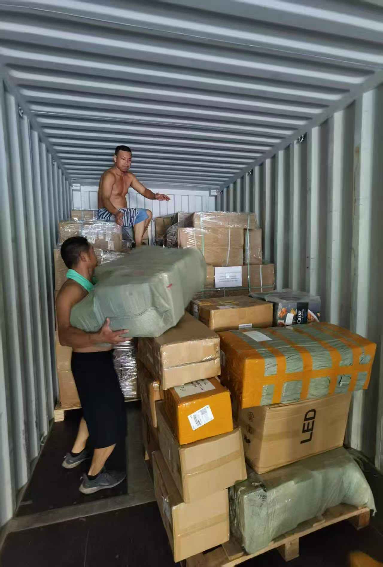 Workers loading cargo into a container