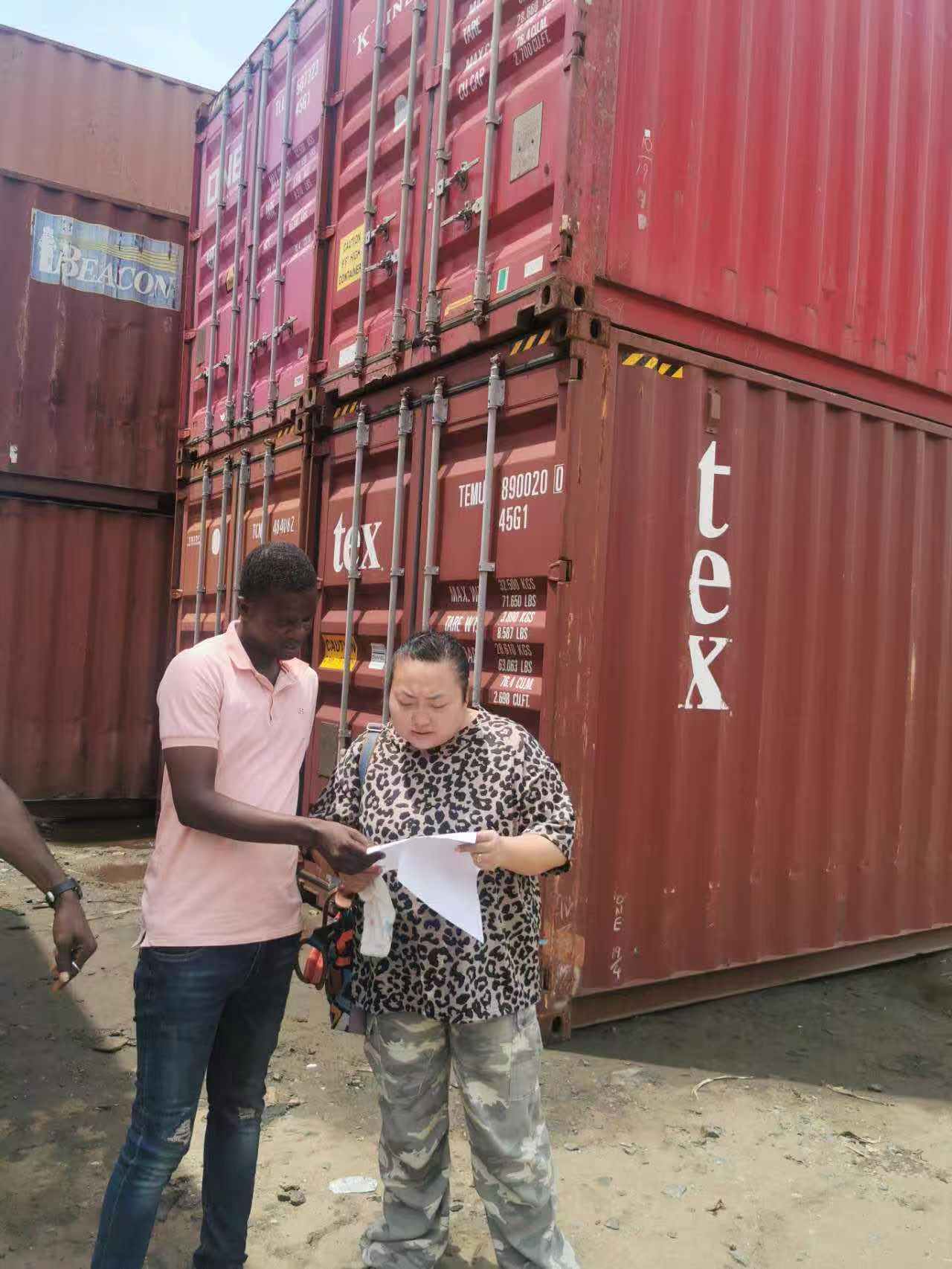Team working beside shipping containers